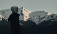 戴帽帅哥站在雪山前图片