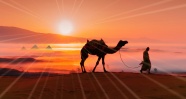 黄昏沙漠骆驼僧侣图片