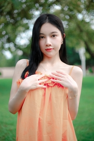 春天户外草地橙色吊带裙性感美女图片