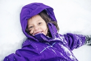 冬季躺在雪地里的可爱小女孩图片