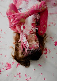 欧美美女躺在地上沾满粉色颜料图片
